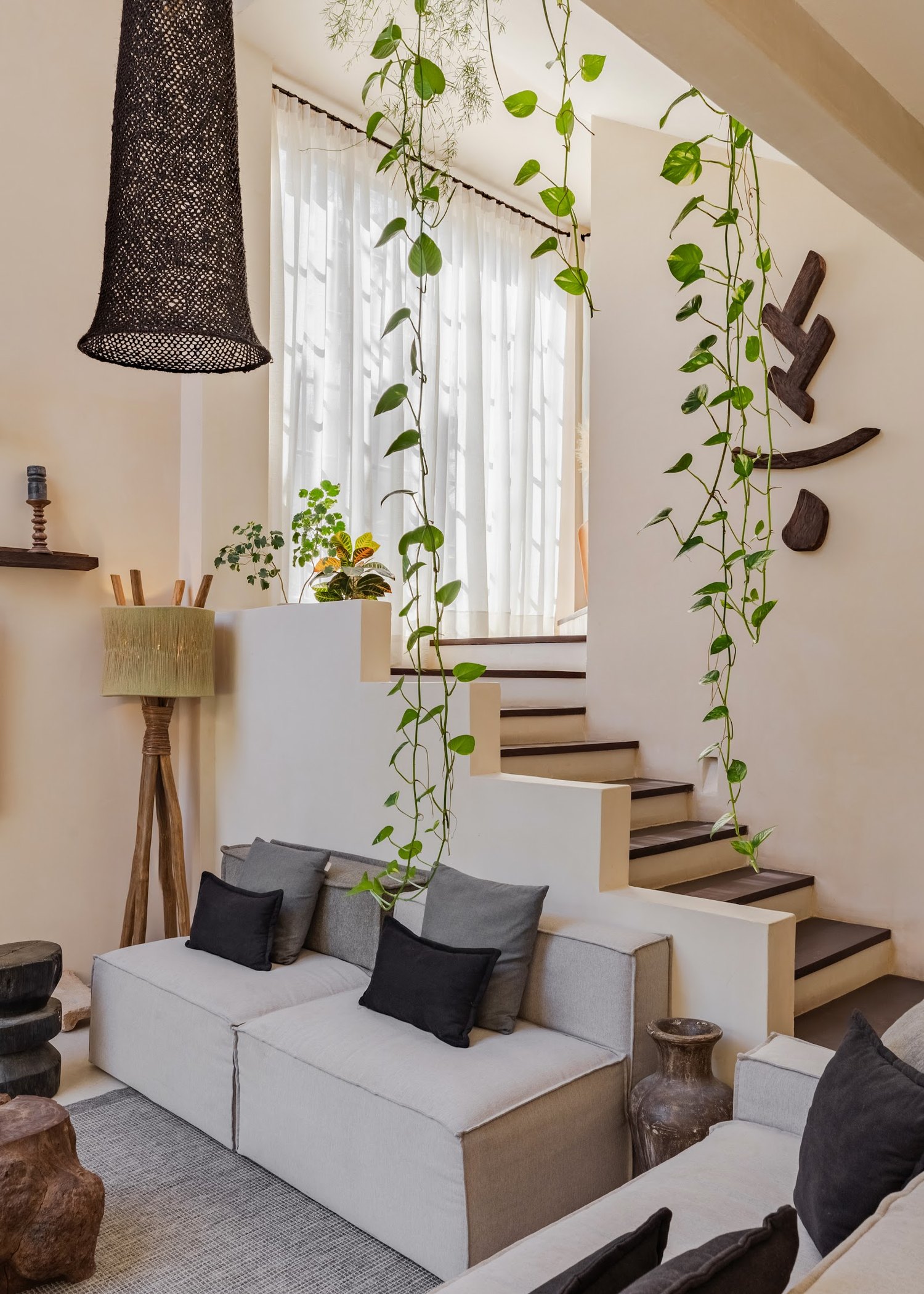 The garden runs straight through the house &mdash; greenery framing nearly every view.