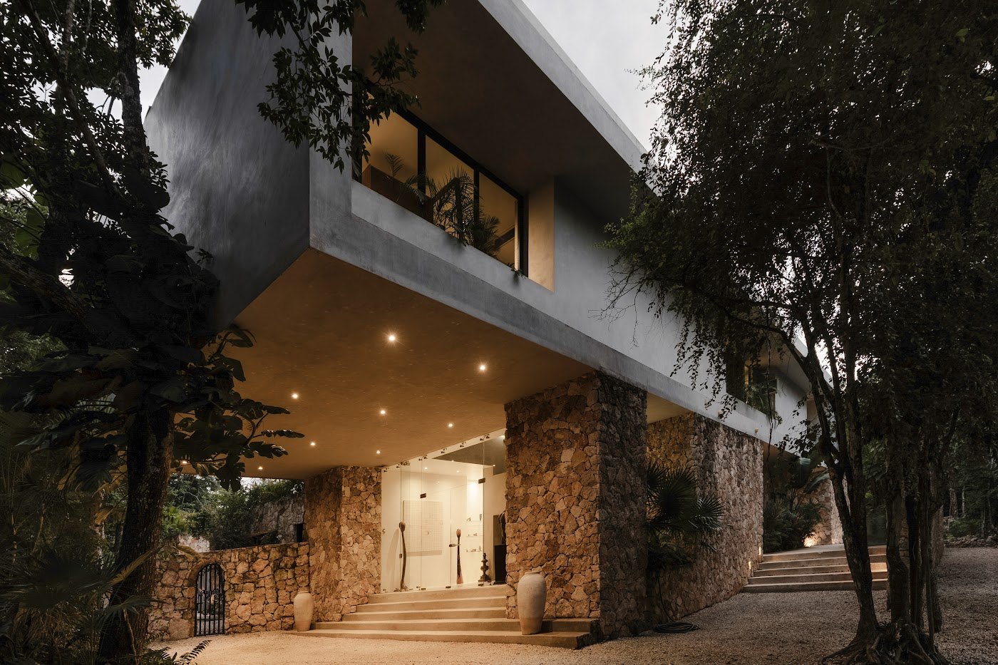 Hand-laid stone and poured concrete — built to frame the jungle rather than fight it.