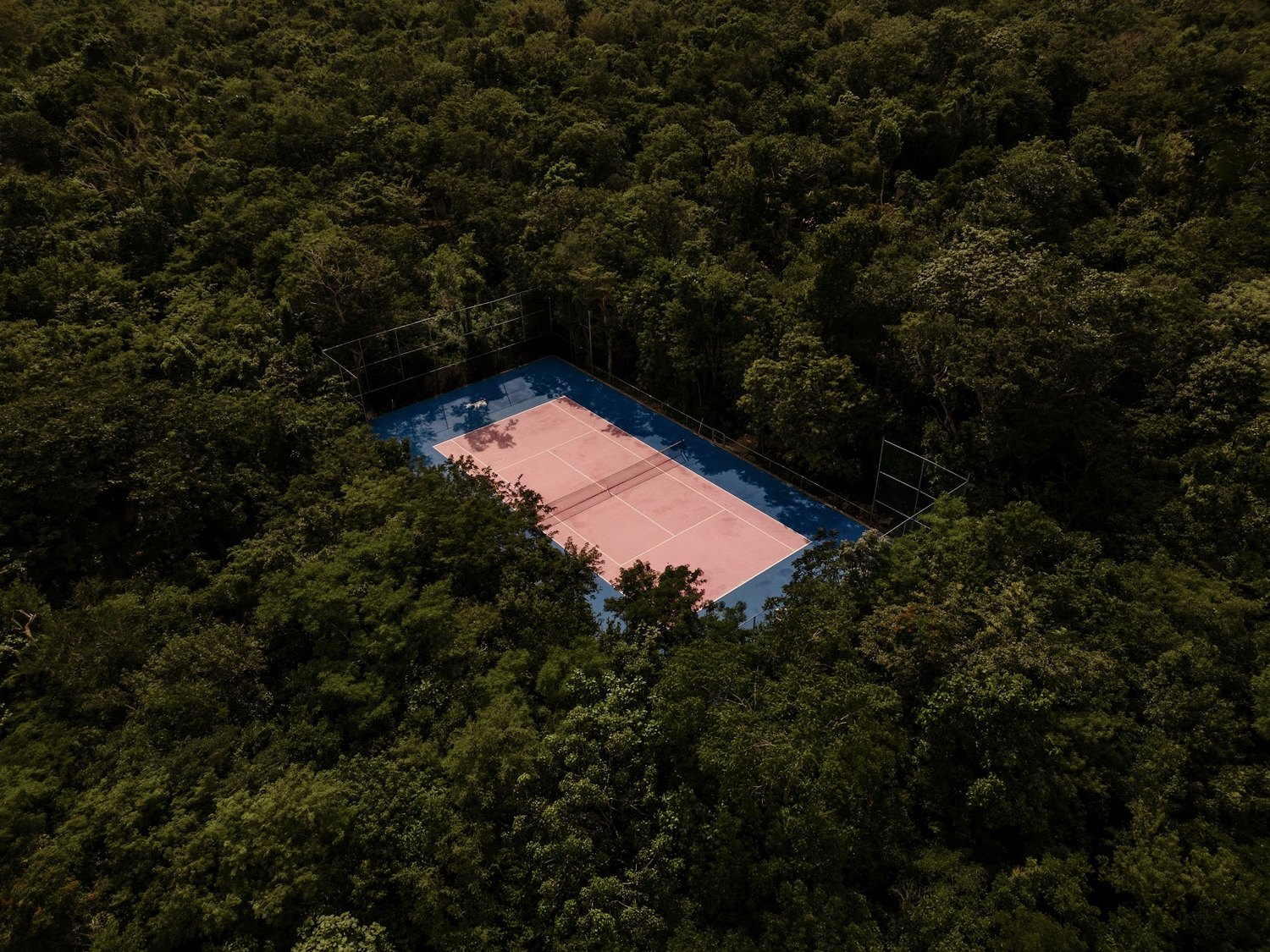 Tucked into the trees on the far side of the grounds — you’d barely know it was there.
